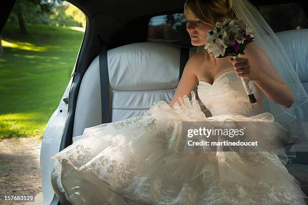 young bride going out the limousine - wedding limo stock pictures, royalty-free photos & images