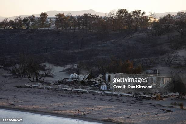 Families relax on Glistra beach at sunset on July 28, 2023 in Lardos, Rhodes, Greece. The popular beach was ravaged by wildfire that also destroyed...