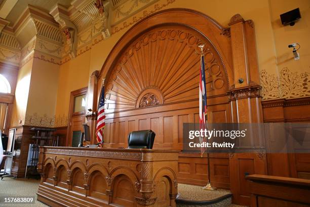 inside of a courtroom with american flags - rättssal bildbanksfoton och bilder