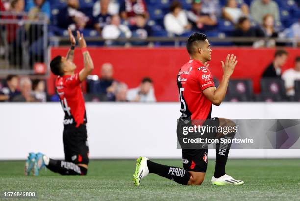 Atlas Fútbol Club defenders Jose Abella and Anderson Santamaría say a prayer before a Leagues Cup Round of 32 match between the New England...