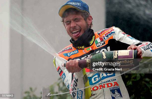 Apr 2002 . Valentino Rossi of Italy celebrates on the podium after winning the first round of the 500cc Motor cycle championship held at the Suzuka...