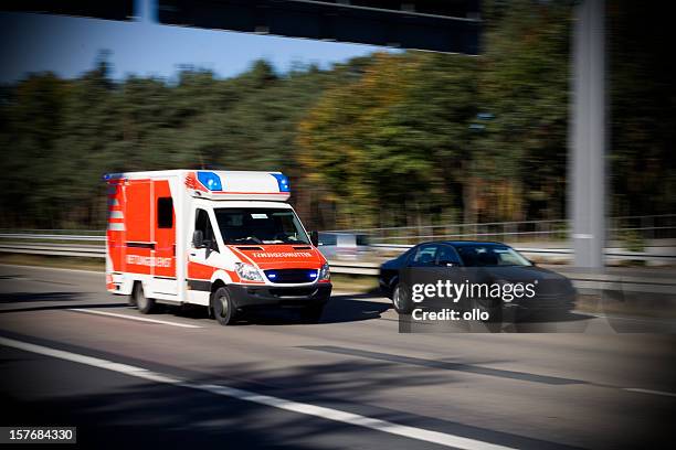 speeding german ambulance on the highway - ambulance lights stock pictures, royalty-free photos & images