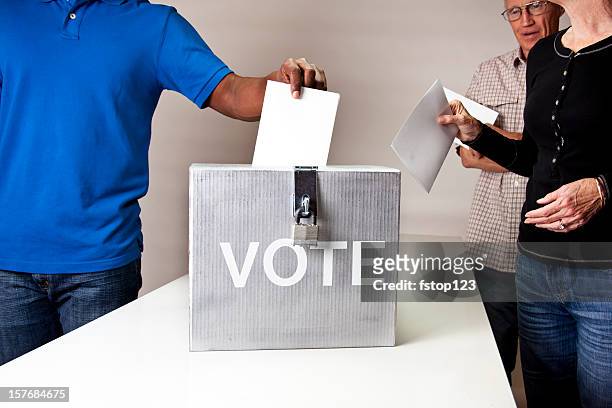 voting. people in line casting vote. ballot box.  multi-ethnic group. - ideeënbus stockfoto's en -beelden