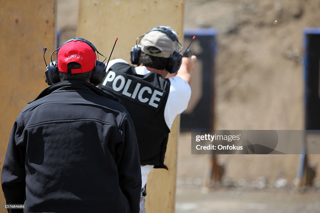 Policeman Officer Shooting 9mm Handgun with Instructor
