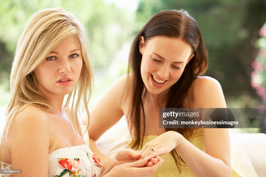 Woman Showing Jealous Friend Engagement Ring