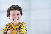 Smiling Jewish boy in striped yellow shirt