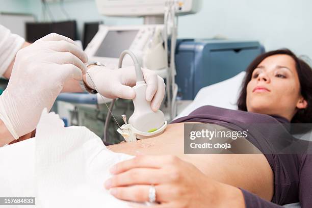doctor making liver biopsy to a young women..supporting with ultrasound - biopsy stock pictures, royalty-free photos & images