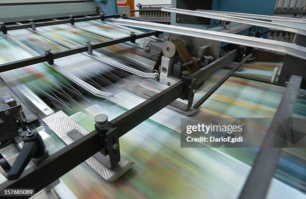 offset printing machine while it's running, close-up - printing industry stock pictures, royalty-free photos & images