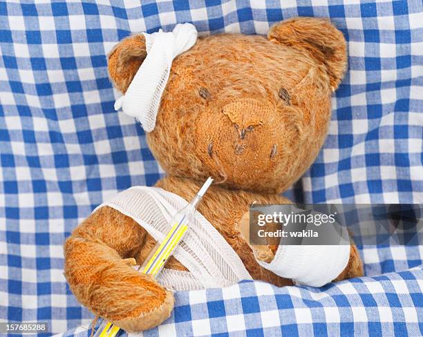sick teddy in bed - head wound stock pictures, royalty-free photos & images