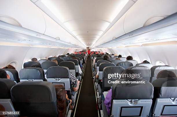 commercial airliner cabin. - inside of plane stock pictures, royalty-free photos & images