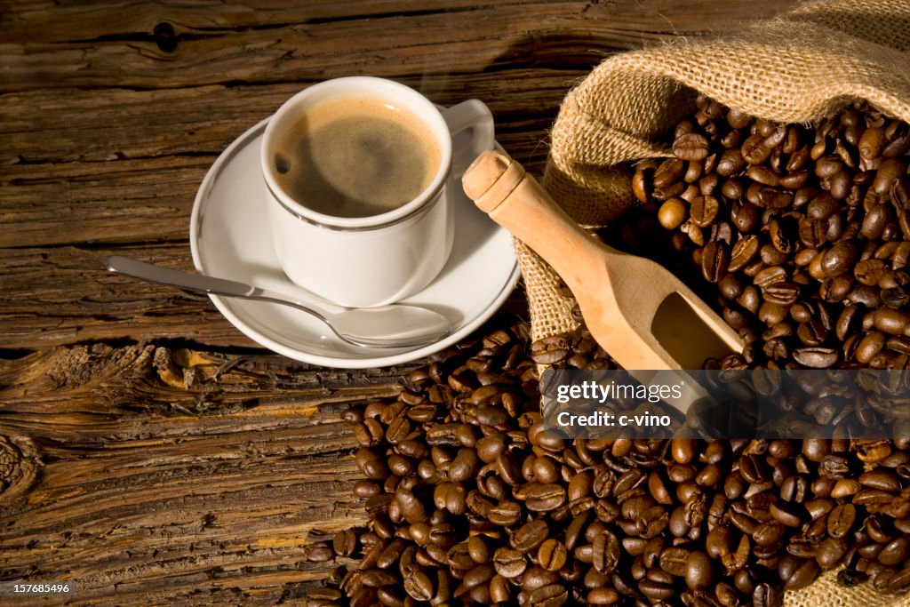 Coffee bean in a jute bag with wood ladle