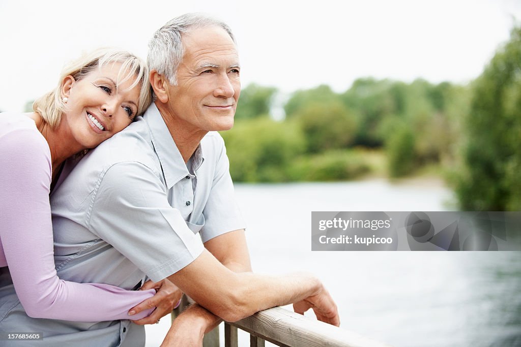 Loving mature woman embracing a man from back