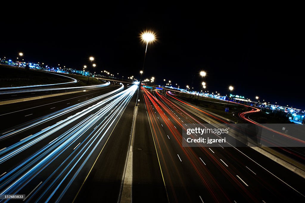 Motion-blurred view of cars on the highway at night