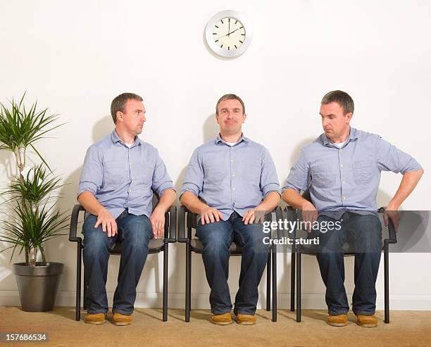 triplets in a waiting room - klonen stockfoto's en -beelden