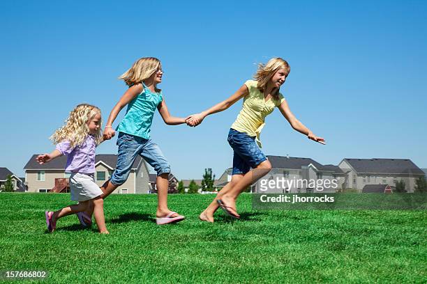 three girls running in the park - girl sandals stock pictures, royalty-free photos & images
