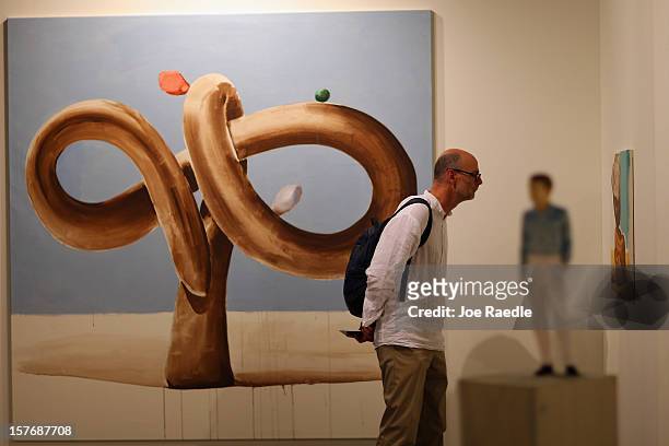 Santiago Caleya looks at the art in the Mai 36 gallery as Art Basel opens at the Miami Beach Convention Center on December 5, 2012 in Miami Beach,...