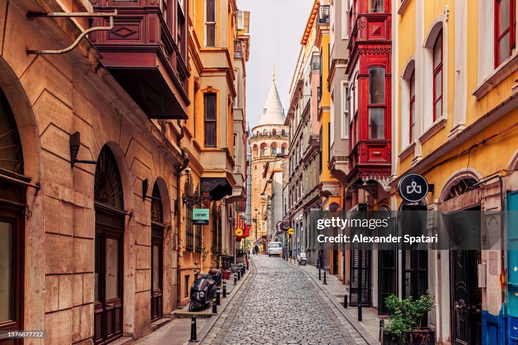 Narrow street with Galata Tower and historic building in Beyoglu district, Istanbul, Turkey