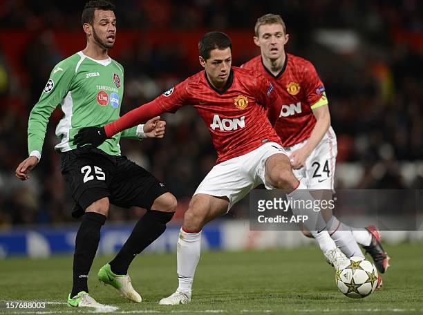 Manchester United's Mexican forward Javier Hernández vies with Cluj's Brazilian midfielder Luis Alberto during the UEFA Champions League group H...