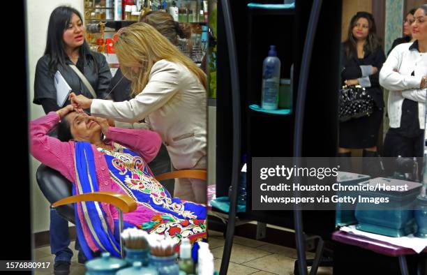 Million for La Voz Sangeeta Dua, of India, owner of Apsara Beauty Center, threads the eyebrows of mother Sunita Dua to demonstrate threading...