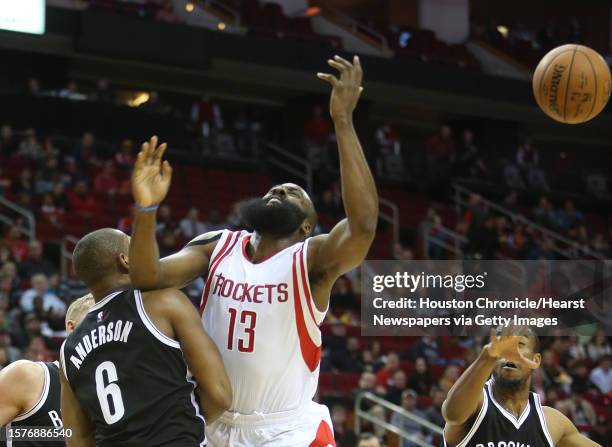 Houston Rockets guard James Harden is blocked by Brooklyn Nets guard Alan Anderson during the first half of the basketball game at the Toyota Center...