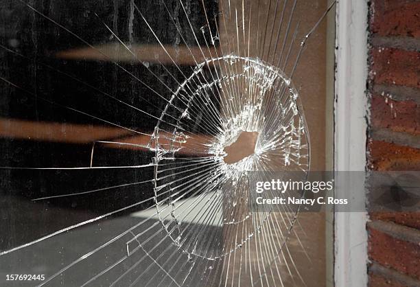 shattered glass in storefront window, vandalism, bullet hole, damage - broken glass pieces stock pictures, royalty-free photos & images