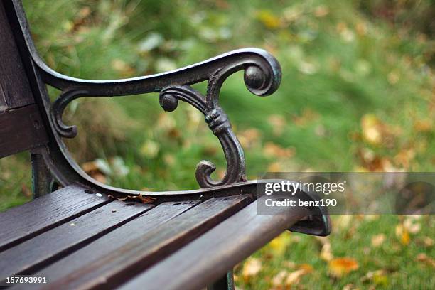 closeup view of a single bench in the park - park bench stock pictures, royalty-free photos & images