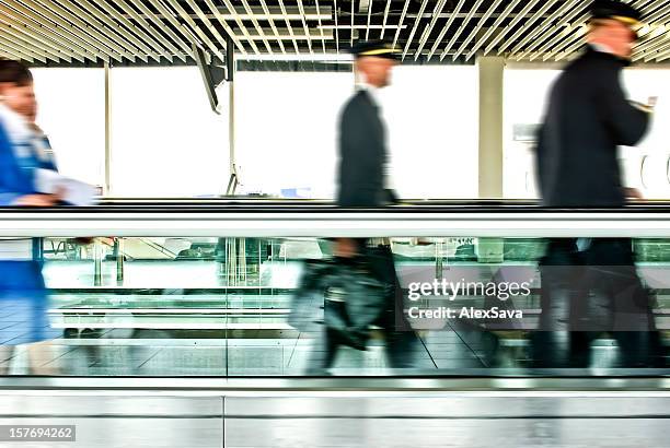 airline staff - travolator stock pictures, royalty-free photos & images