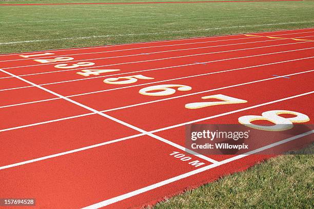 100 meter start line on red eight lanes running track - race day stock pictures, royalty-free photos & images