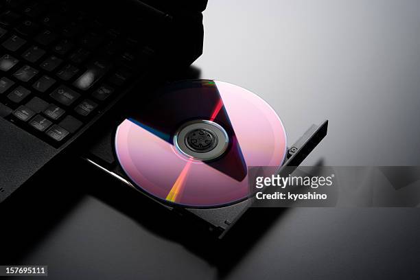 inserting a cd into a laptop computer with copy space - rom stock pictures, royalty-free photos & images
