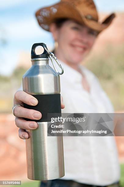 cowgirl with a stainless steel water bottle - carabiner stock pictures, royalty-free photos & images