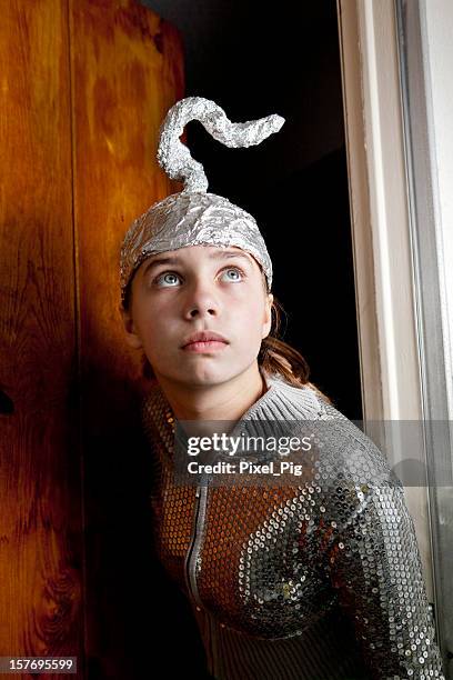 girl with tinfoil hat looking at something - magic doors stock pictures, royalty-free photos & images