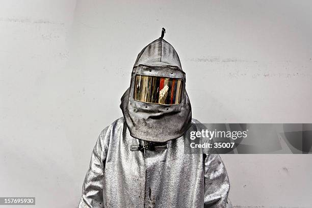 portrait of a steel worker in a silver suit with a hood - 防護服 個照片及圖片檔