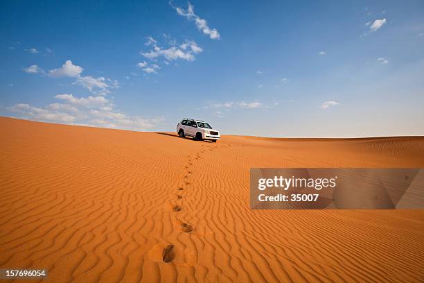 4wd car and footprints in the desert - desert stock pictures, royalty-free photos & images