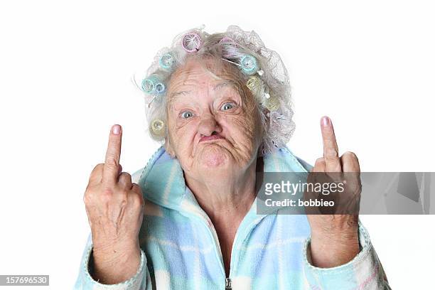 senior humor: cranky woman making faces and flipping the bird. - cruel stock pictures, royalty-free photos & images
