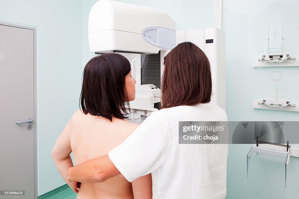 Nurse with young women having a mammogram