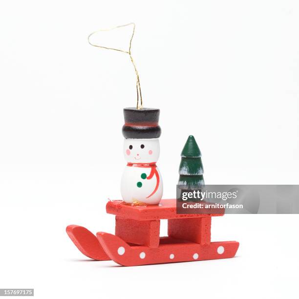 snowman on sled - christmas bauble isolated stock pictures, royalty-free photos & images