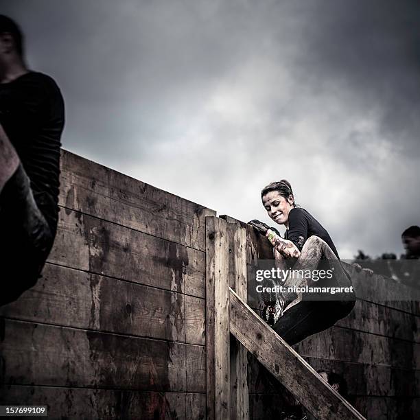 determination: female athlete in competition - assault courses stock pictures, royalty-free photos & images