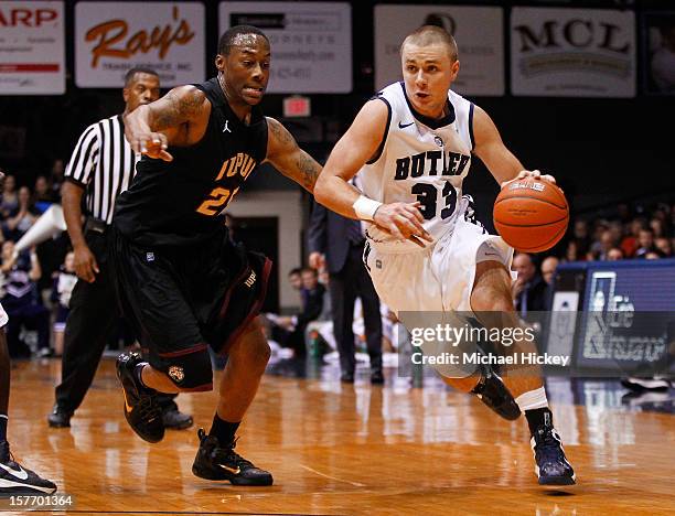 Chase Stigall of the Butler Bulldogs dribbles against John Hart of the IUPUI Jaguars at Hinkle Fieldhouse on December 5, 2012 in Indianapolis,...