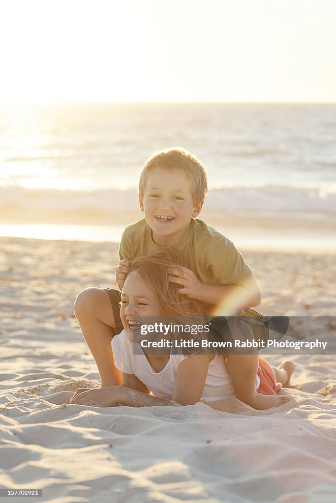 Boy and girl playing at city beach