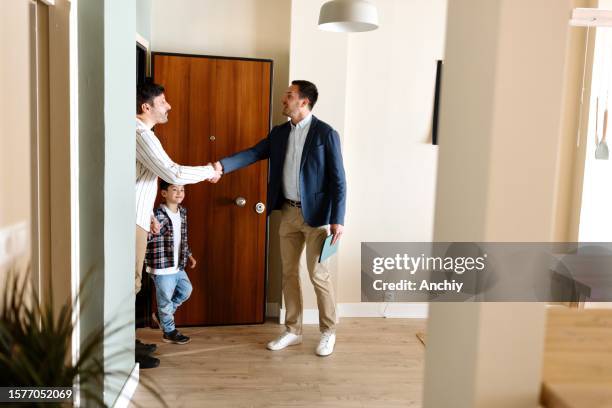 estate agent showing prospective buyers around property - real estate showing stock pictures, royalty-free photos & images