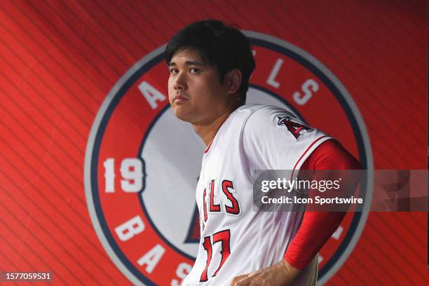 Los Angeles Angels designated hitter Shohei Ohtani looks on in the dugout during the MLB game between the Seattle Mariners and the Los Angeles Angels...