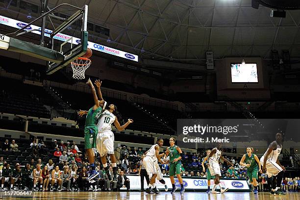 Brittany Kennedy of the Florida Gulf Coast Eagles shoots as Courtney Williams of the South Florida Bulls defends during the game at the Sun Dome on...