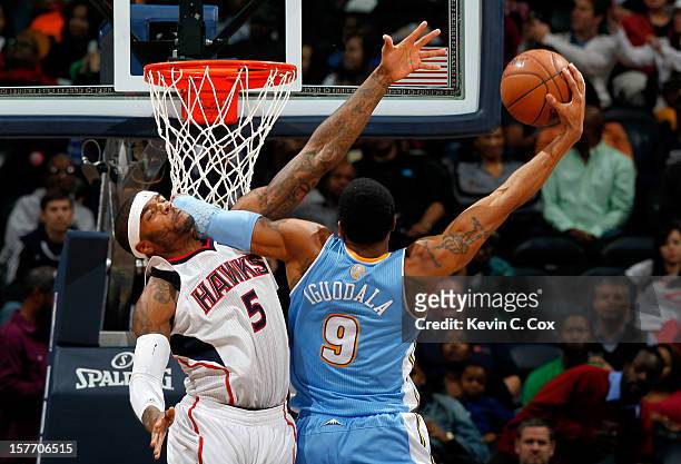 Andre Iguodala of the Denver Nuggets dunks and draws a foul from Josh Smith of the Atlanta Hawks at Philips Arena on December 5, 2012 in Atlanta,...