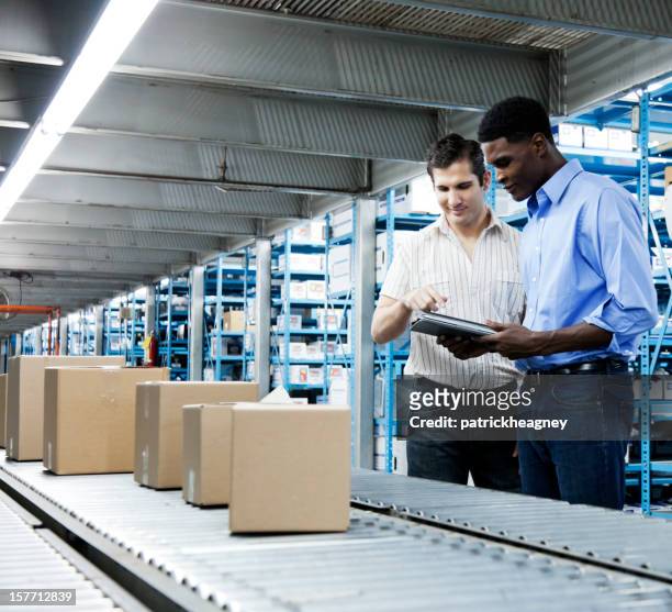 inventory inspection on conveyor belt with a digital tablet - boxes conveyor belt stockfoto's en -beelden