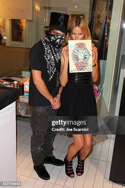 Artist Alec Monopoly and model Karolina Kurkova attend the Haute Living and Roger Dubuis dinner hosted by Daphne Guinness at Azur on December 5, 2012...