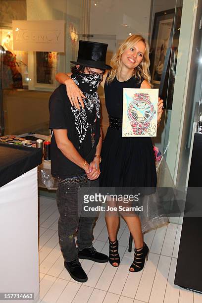 Artist Alec Monopoly and model Karolina Kurkova attend the Haute Living and Roger Dubuis dinner hosted by Daphne Guinness at Azur on December 5, 2012...
