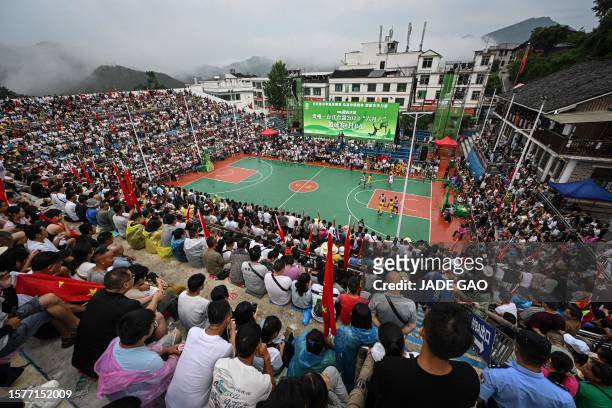 This photo taken on July 30, 2023 shows a general view of spectators watching the grassroots basketball competition CunBA in Taipan village, Taijiang...