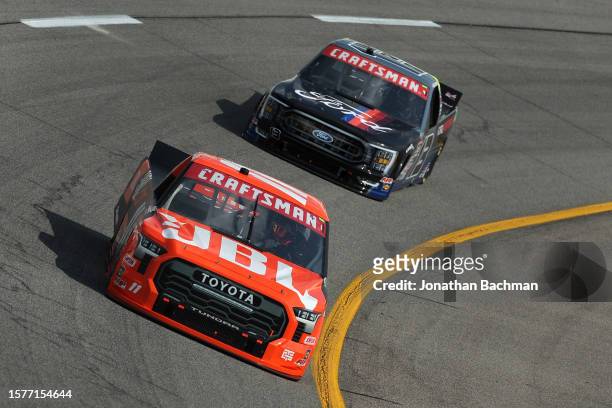 Corey Heim, driver of the JBL Toyota, and Hailie Deegan, driver of the Ford Performance Ford, drive during practice for the NASCAR Craftsman Truck...