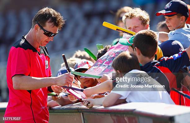 Brett Lee signs autographs during a Sydney Sixers training session at Sydney Cricket Ground on December 6, 2012 in Sydney, Australia.