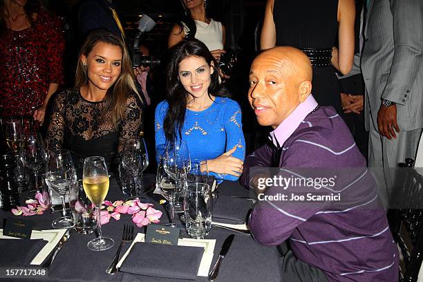 Russell Simmons and Hana Nitsche attend the Haute Living and Roger Dubuis dinner hosted By Daphne Guinness at Azur on December 5, 2012 in Miami...